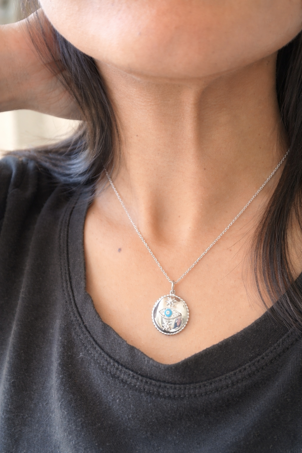 silver necklace in evil eye