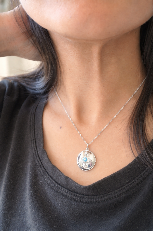 silver necklace in evil eye