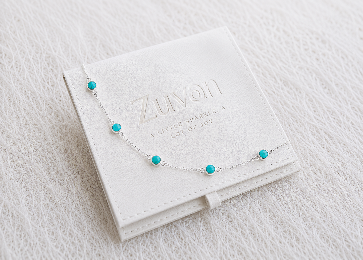 Silver necklace with turquoise beads on a Zuvan jewelry box
